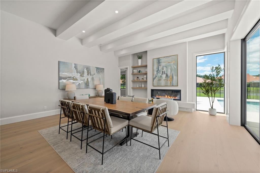 207 Monterey Drive Naples, FL 34119 - Photo 14 of 47 a view of a dining room with furniture window and wooden floor