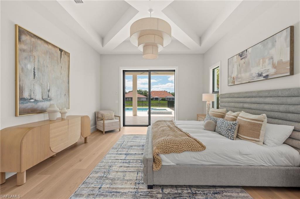 207 Monterey Drive Naples, FL 34119 - Photo 17 of 47 a spacious bedroom with a large bed and a large window