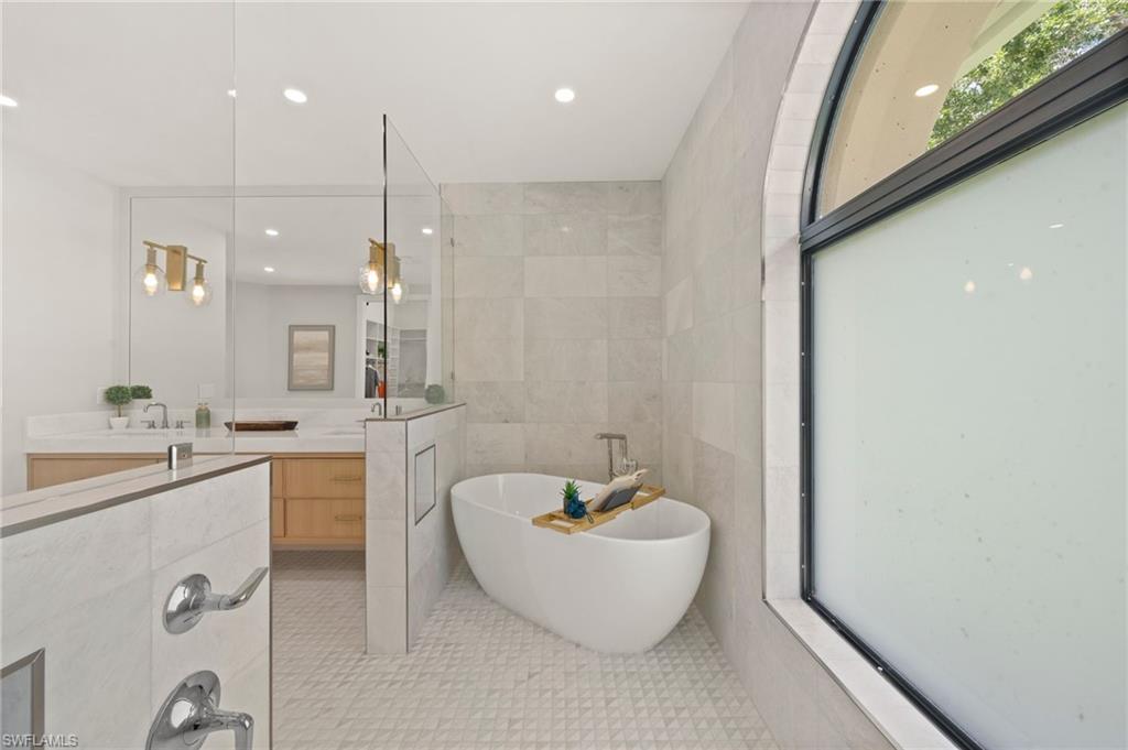 207 Monterey Drive Naples, FL 34119 - Photo 22 of 47 a spacious bathroom with a bathtub and sink