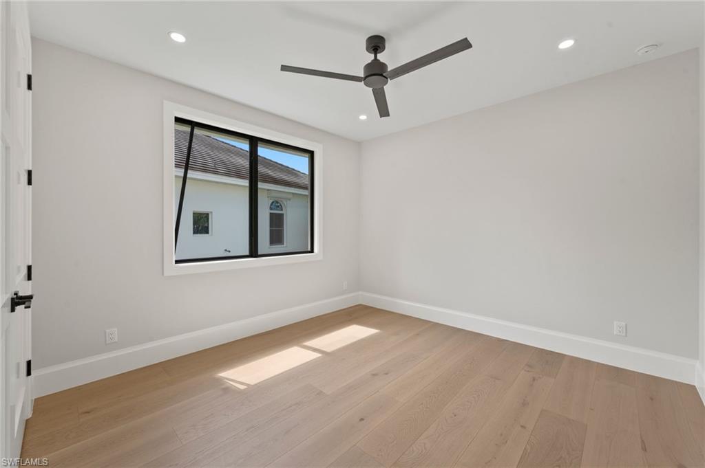 207 Monterey Drive Naples, FL 34119 - Photo 28 of 47 wooden floor in an empty room with a window