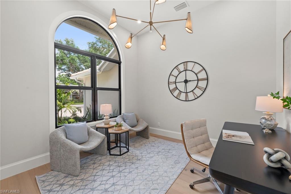 207 Monterey Drive Naples, FL 34119 - Photo 32 of 47 a living room with furniture a table and a large window