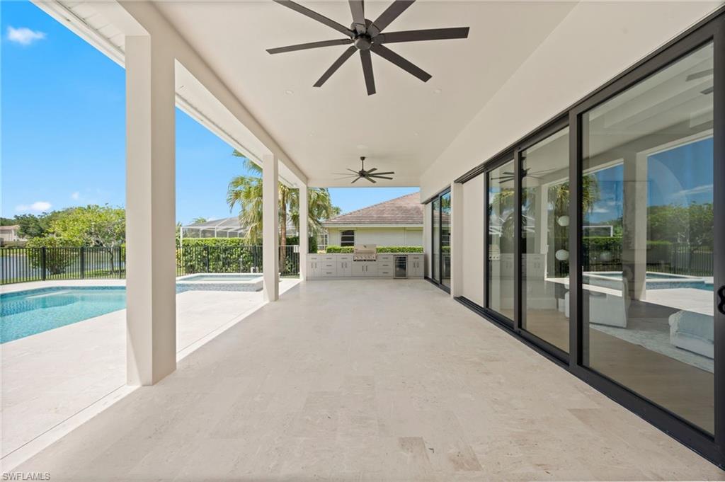 207 Monterey Drive Naples, FL 34119 - Photo 36 of 47 a view of a porch with furniture and floor to ceiling window