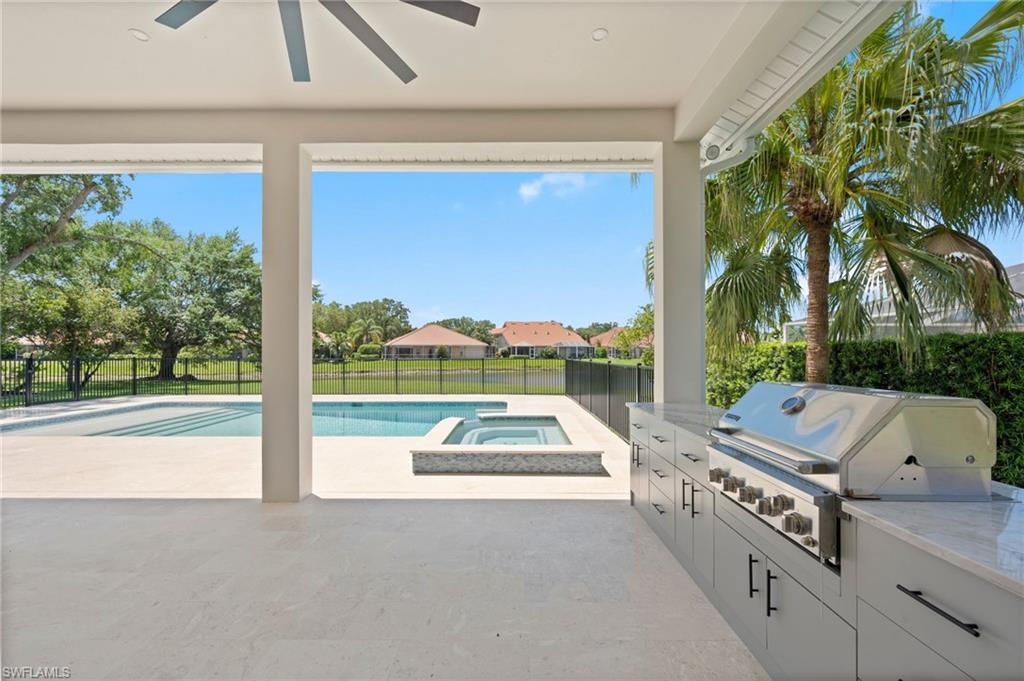 207 Monterey Drive Naples, FL 34119 - Photo 38 of 47 a view of swimming pool with seating area and car parked