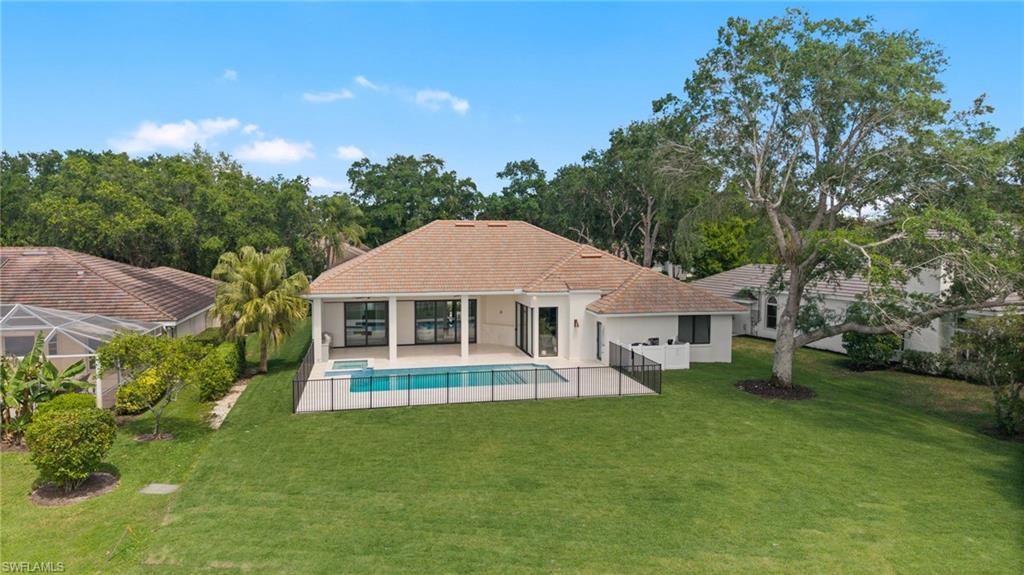 207 Monterey Drive Naples, FL 34119 - Photo 45 of 47 a view of a house with a backyard porch and sitting area