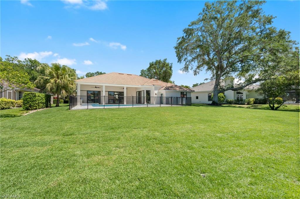 207 Monterey Drive Naples, FL 34119 - Photo 47 of 47 a front view of house with yard and green space