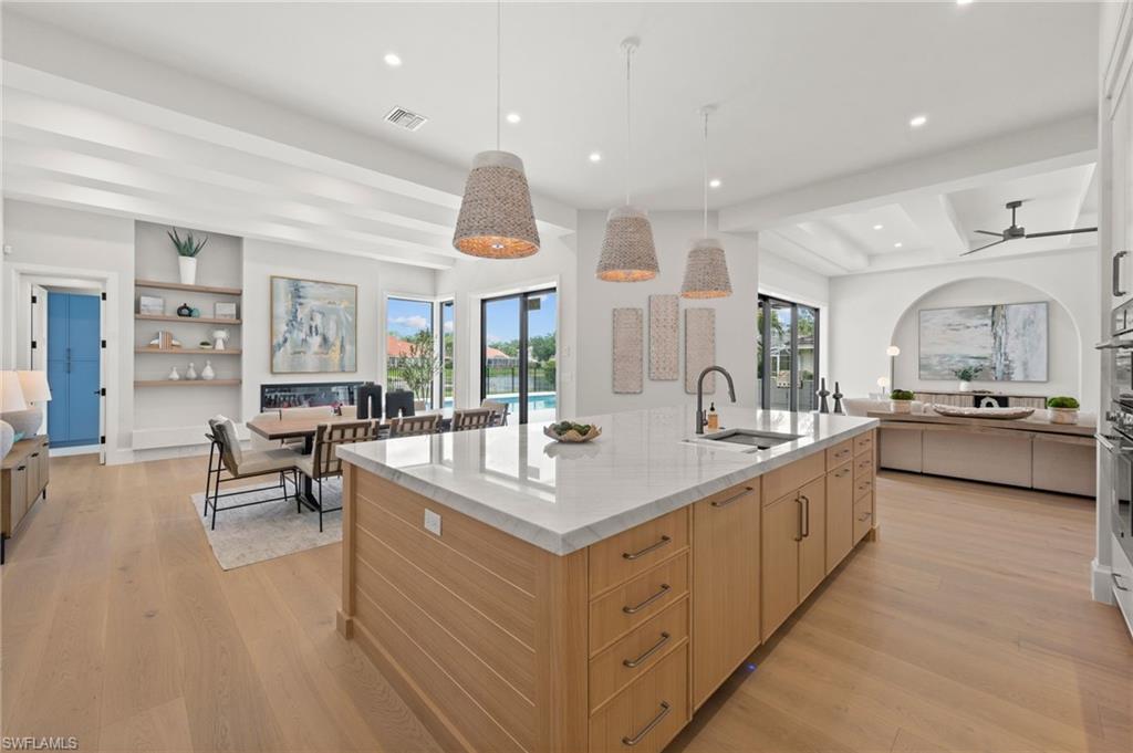 207 Monterey Drive Naples, FL 34119 - Photo 6 of 47 a large white kitchen with a large window and stainless steel appliances