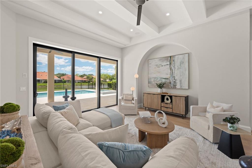 207 Monterey Drive Naples, FL 34119 - Photo 10 of 47 a living room with furniture and a large window