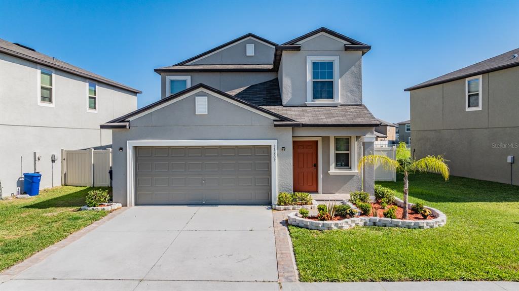 a front view of a house with garden