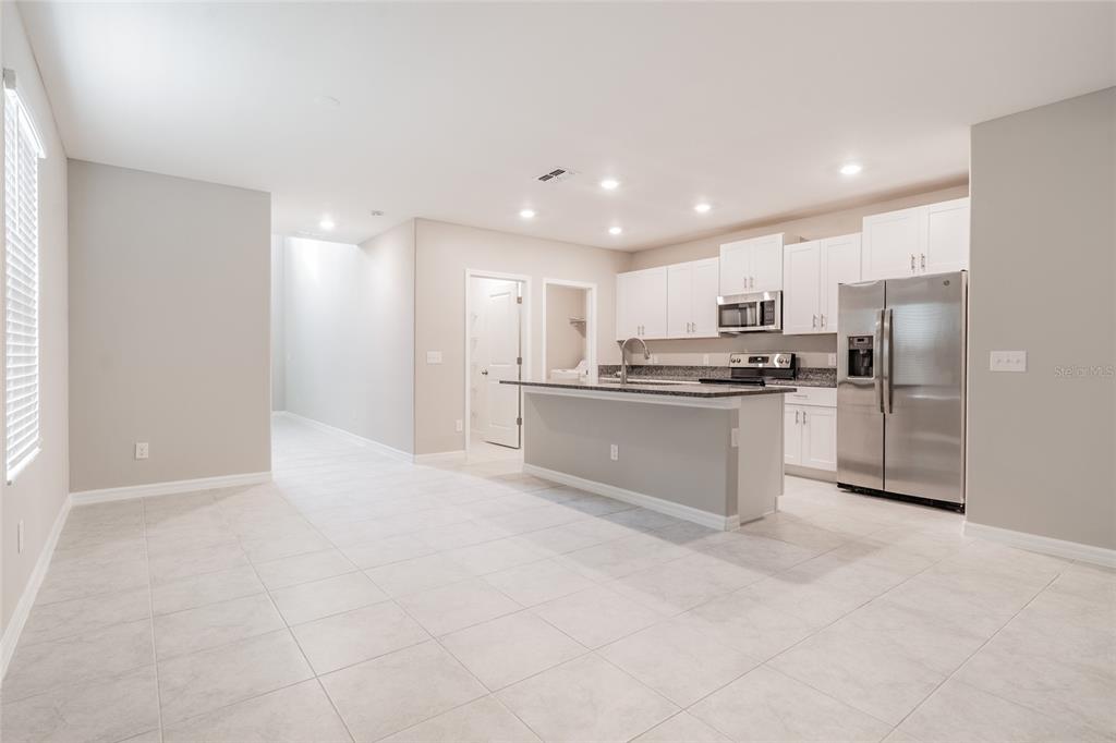 31807 Barrel Wave Way Wesley Chapel, FL 33545 - Photo 14 of 61 a kitchen with stainless steel appliances a refrigerator sink and microwave