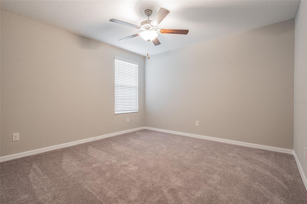 31807 Barrel Wave Way Wesley Chapel, FL 33545 - Photo 16 of 61 an empty room with windows and fan
