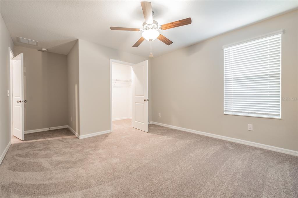 31807 Barrel Wave Way Wesley Chapel, FL 33545 - Photo 17 of 61 an empty room with windows and fan