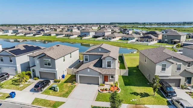 an aerial view of a house with a swimming pool yard and outdoor seating