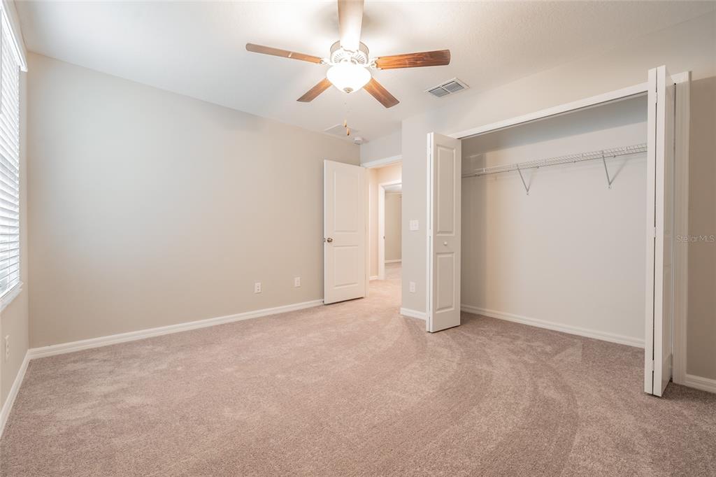 31807 Barrel Wave Way Wesley Chapel, FL 33545 - Photo 21 of 61 an empty room with a ceiling fan and a window
