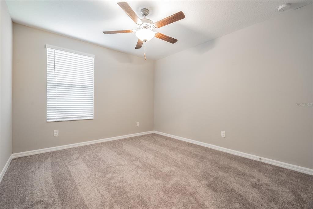 31807 Barrel Wave Way Wesley Chapel, FL 33545 - Photo 22 of 61 an empty room with a window and a fan