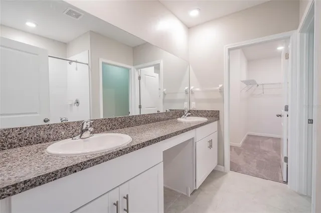 a kitchen with granite countertop stainless steel appliances a stove sink and microwave