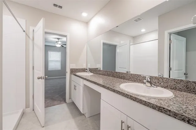 a kitchen with stainless steel appliances granite countertop a stove top oven a sink a refrigerator and a granite counter tops