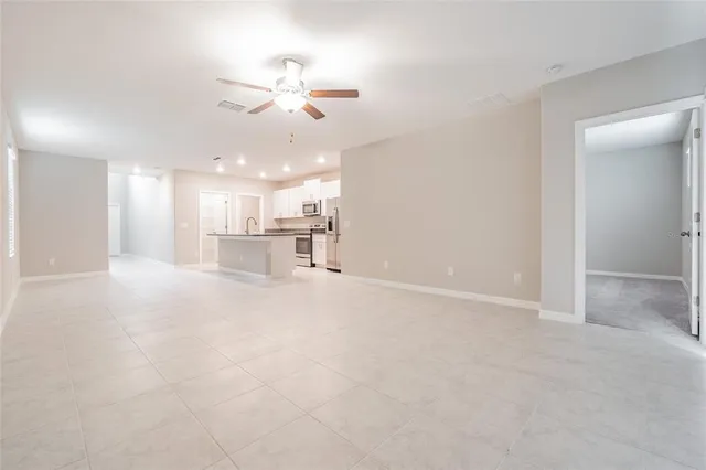 a house that is sitting in the grass with large windows