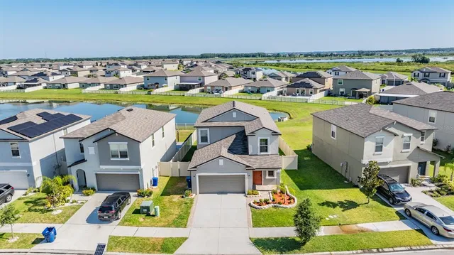an aerial view of a house with a swimming pool yard and outdoor seating