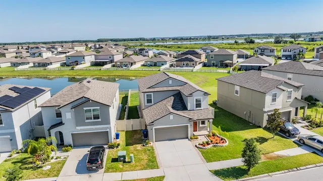 a aerial view of a house with a swimming pool yard and outdoor seating