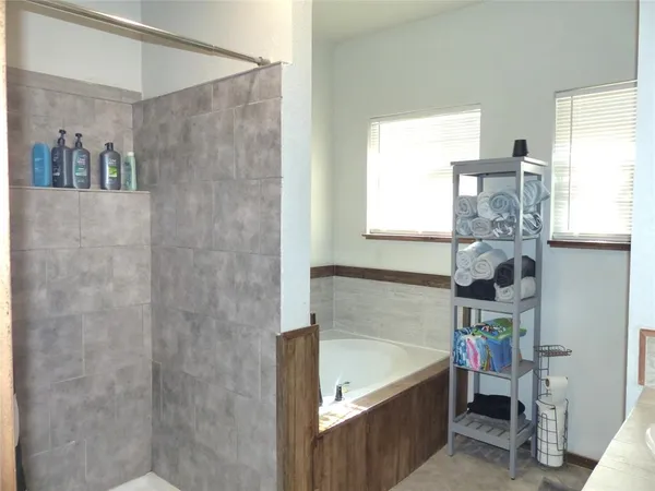 a bathroom with a bathtub and a shower