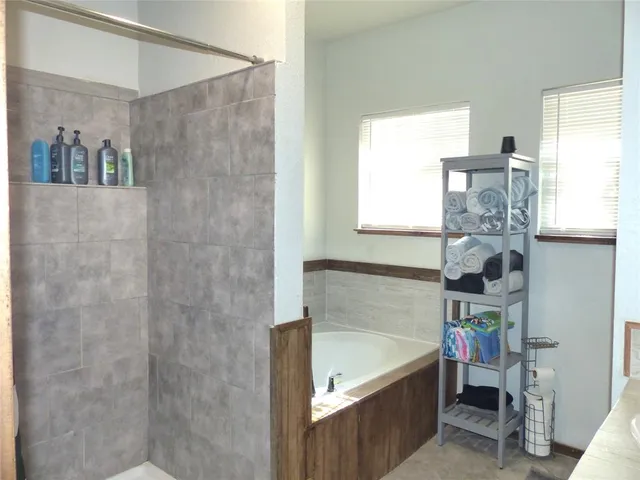 a bathroom with a bathtub and a shower