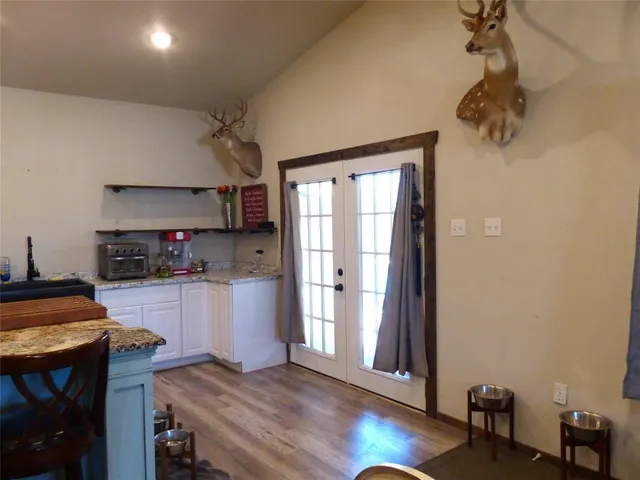 a kitchen with a wooden floor and a window