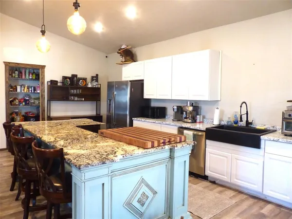 a kitchen with stainless steel appliances granite countertop a sink and cabinets