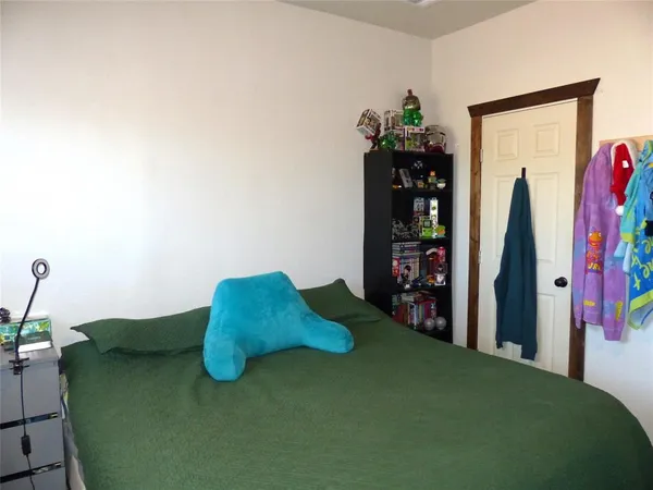 a living room with furniture and a book shelf