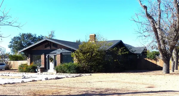 a view of a house with a yard covered in snow