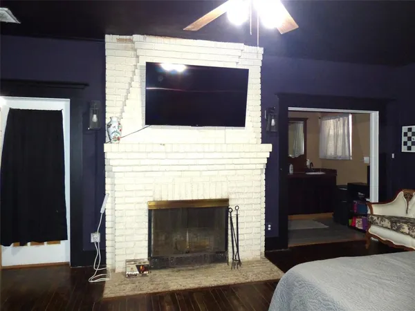a living room with a fireplace and a flat screen tv