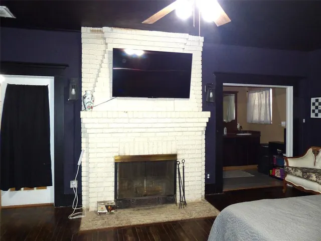 a living room with a fireplace and a flat screen tv