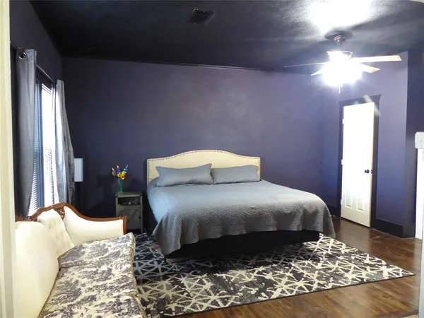 a bedroom with a bed and a mirror