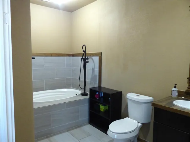 a bathroom with a bathtub and a toilet