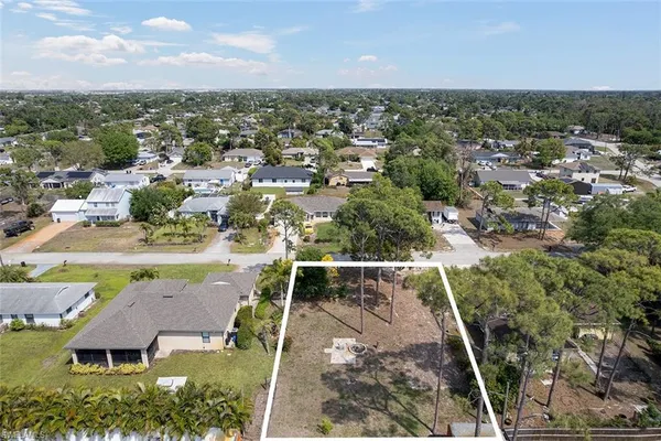 an aerial view of residential houses with outdoor space and river