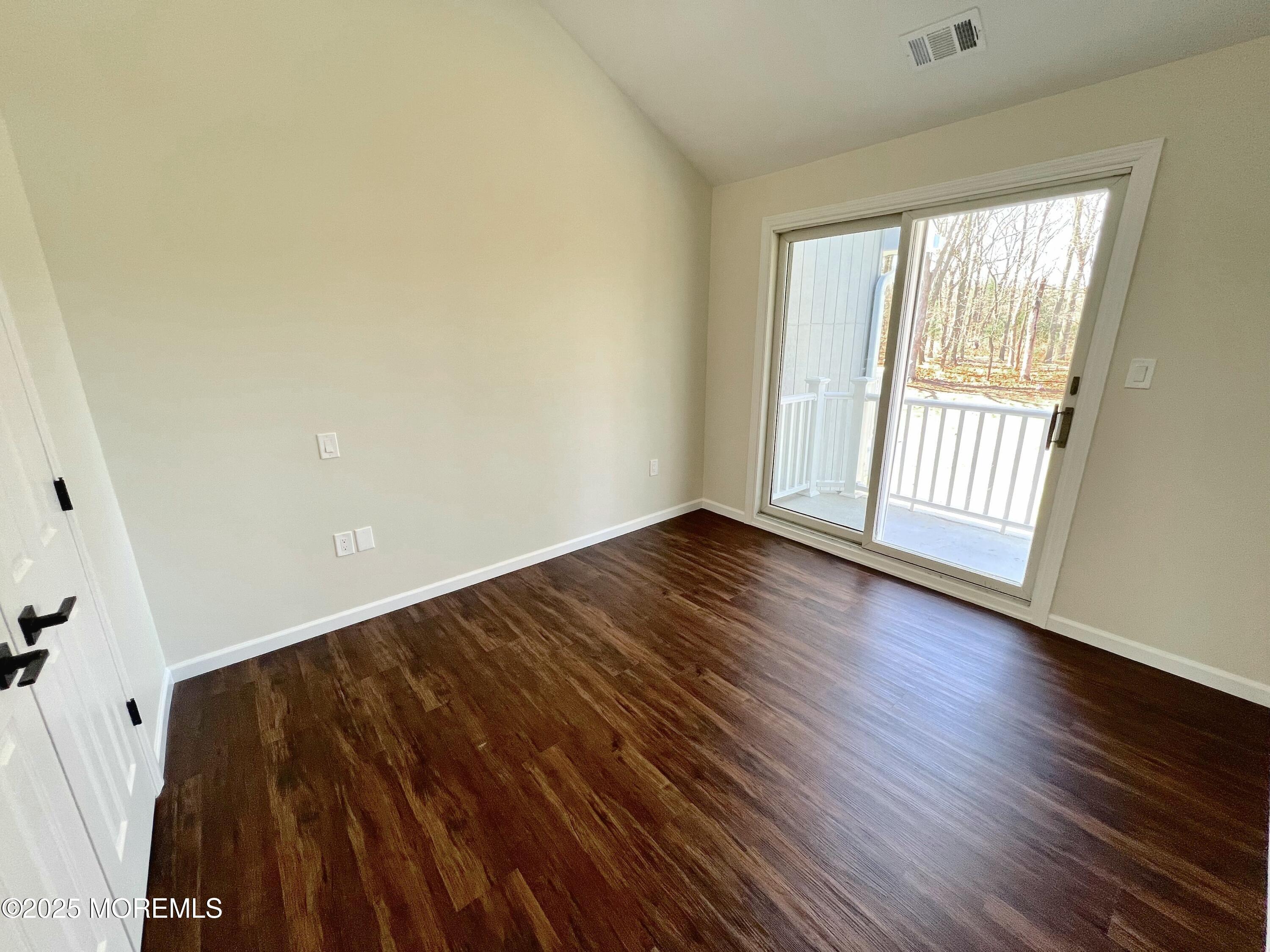 155 Hamilton Road Tinton Falls, NJ 07724 - Photo 23 of 49 a view of an empty room with wooden floor and a window