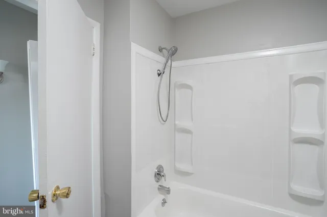 a bathroom with a shower and a bath tub