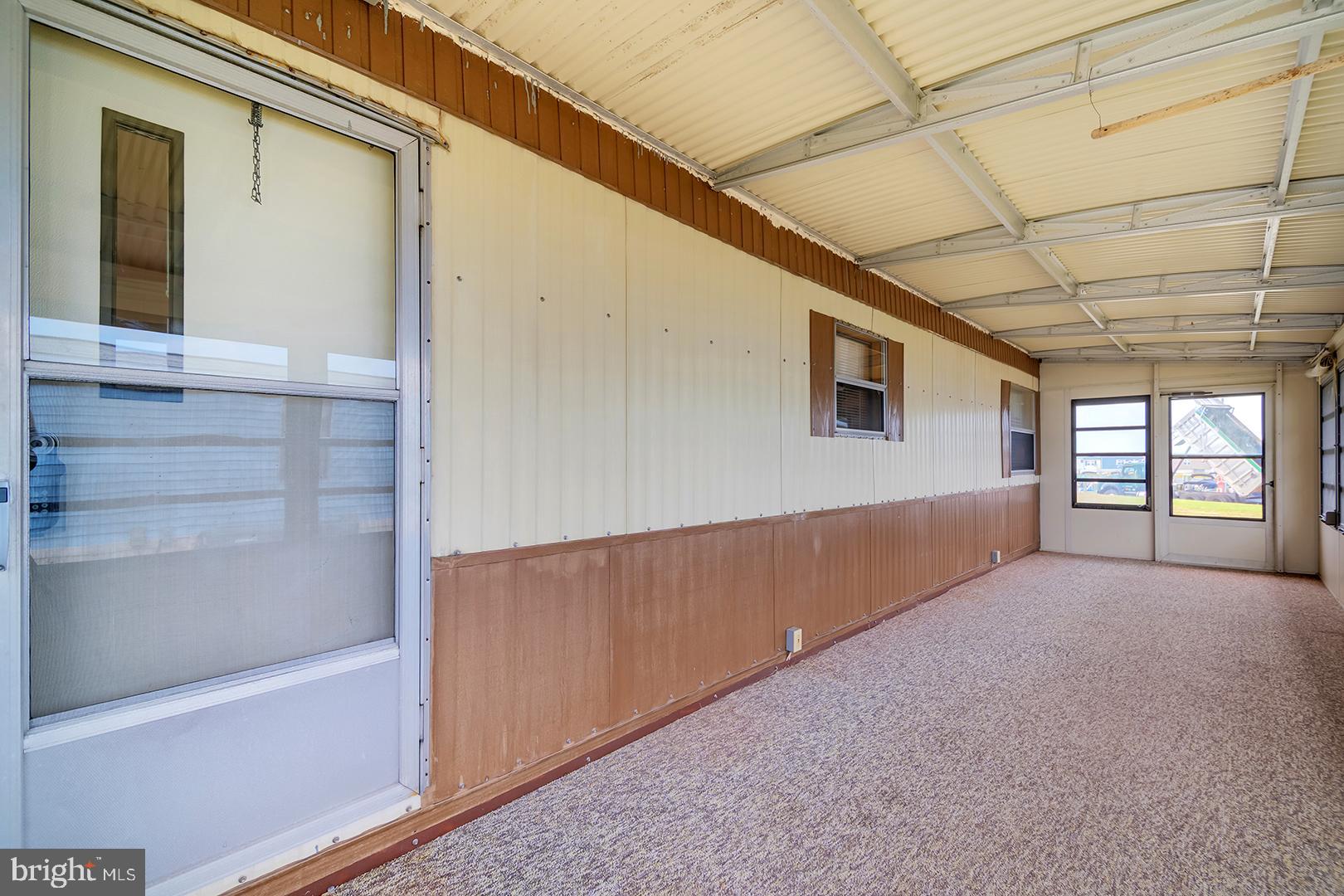 38052 Rabbit Road Ocean View, DE 19970 - Photo 6 of 32 Screened porch @ front door to home