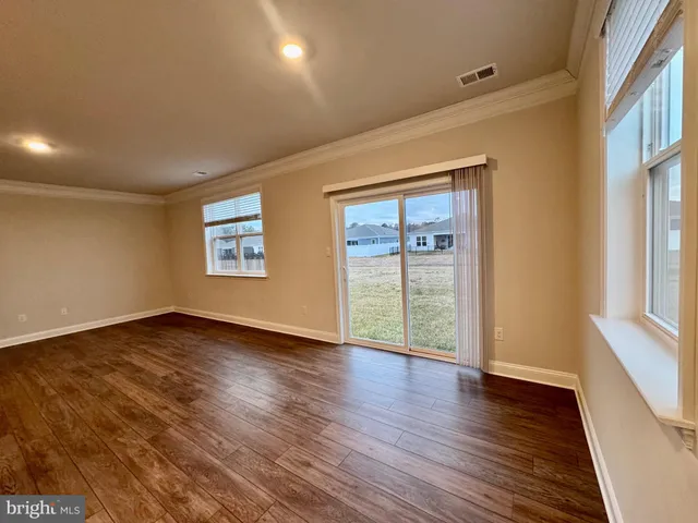 a white toilet sitting next to a white wall