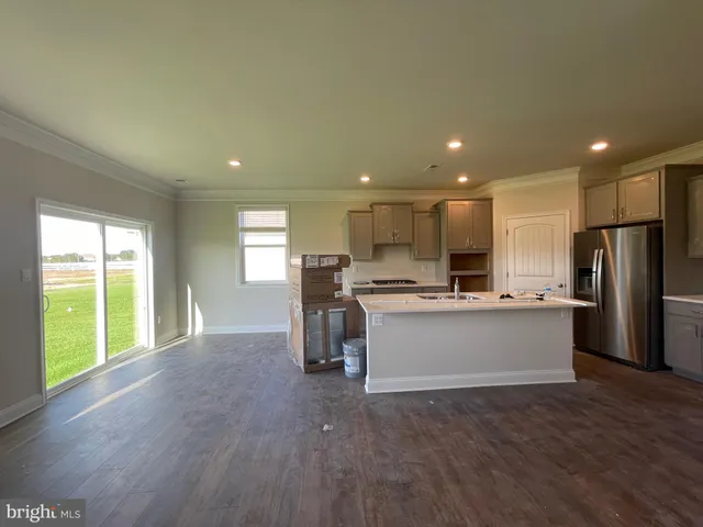 a kitchen with a refrigerator and a sink