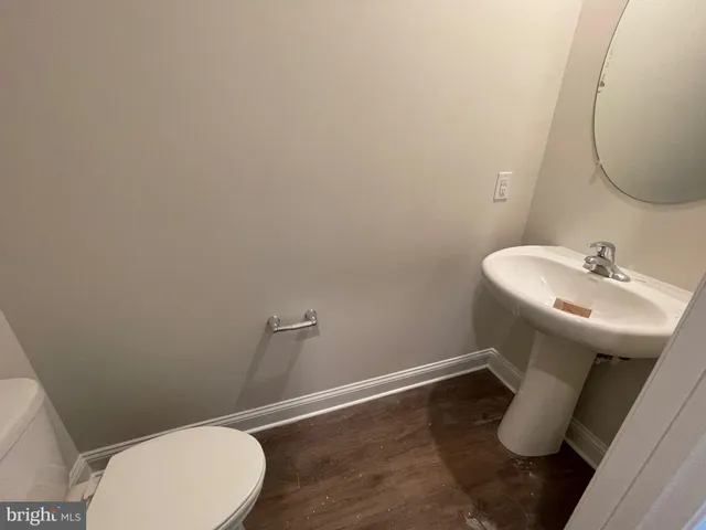 an empty room with a window and a kitchen