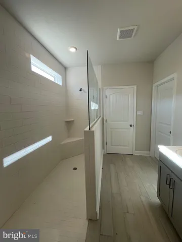 a bathroom with a shower and a sink