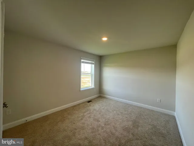 an empty room with a empty space and windows