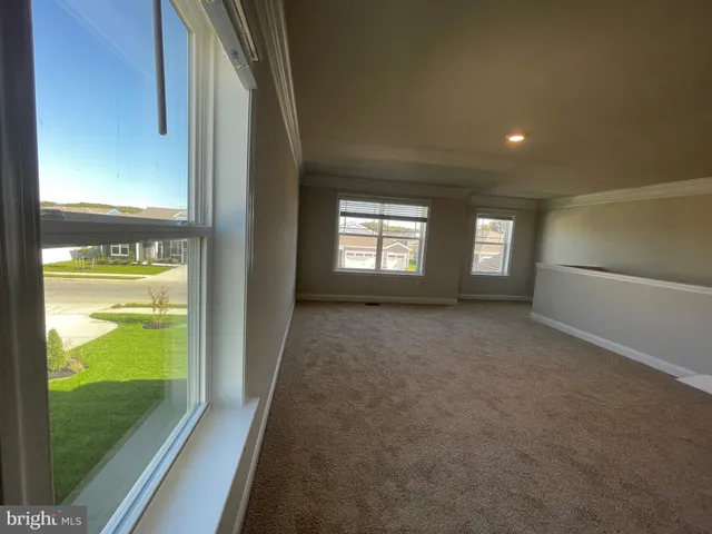 a view of an empty room and a window