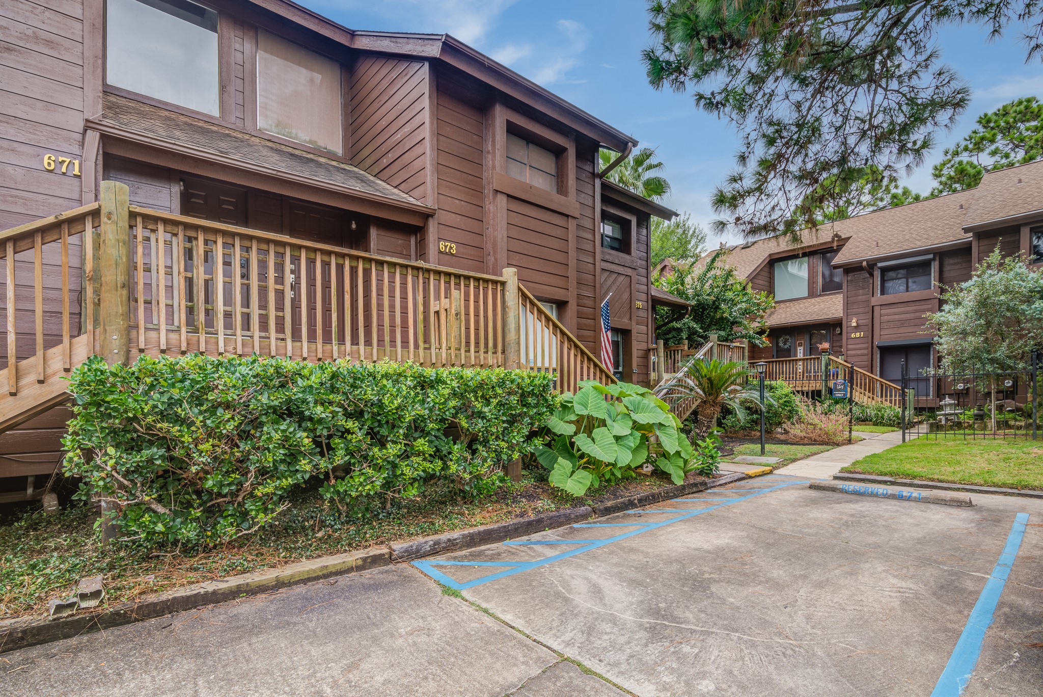 671 Davis Road League City, TX 77573 - Photo 25 of 34 a view of a house with a yard and table and chairs under an umbrella