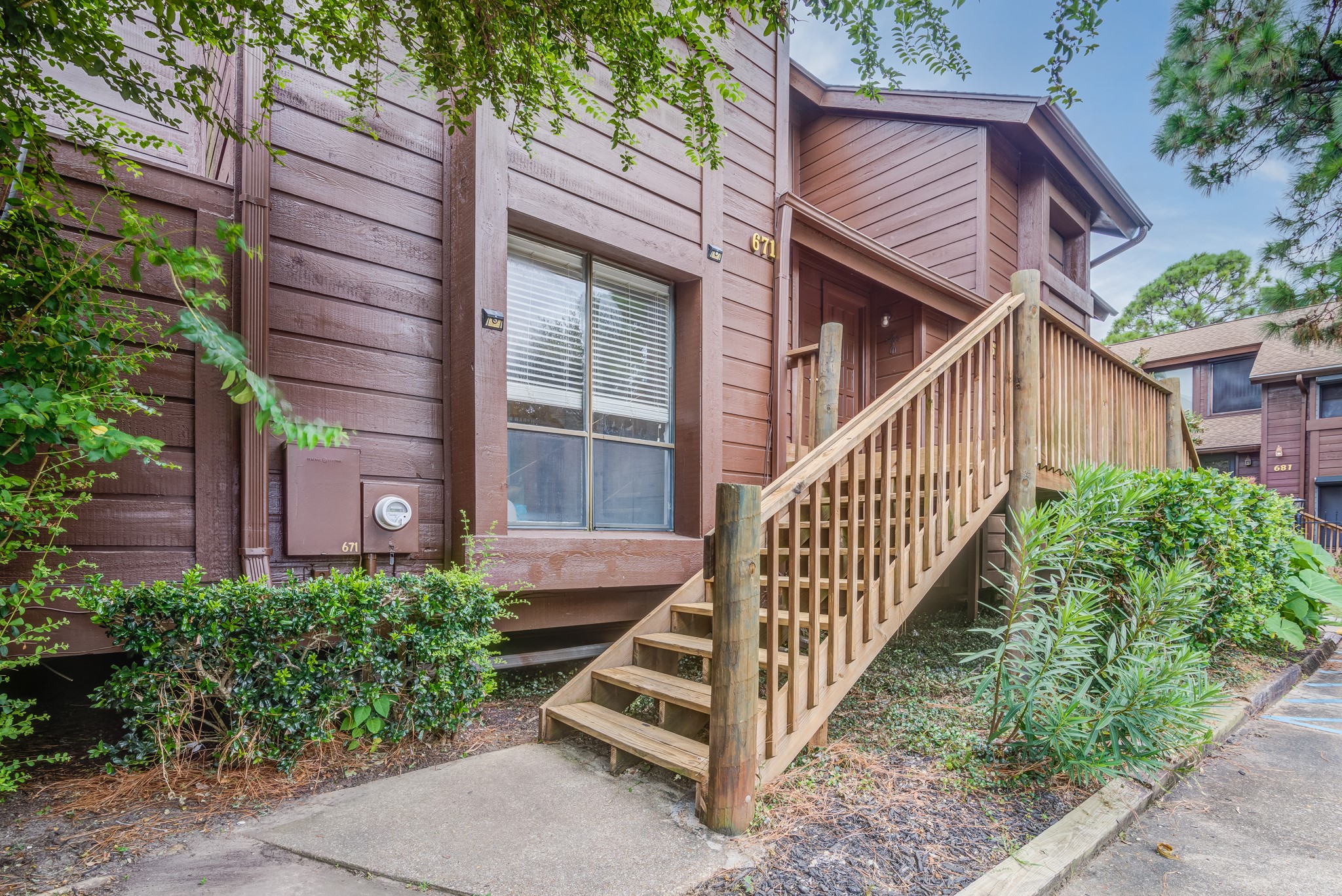 671 Davis Road League City, TX 77573 - Photo 26 of 34 a view of a house with wooden stairs and a small yard