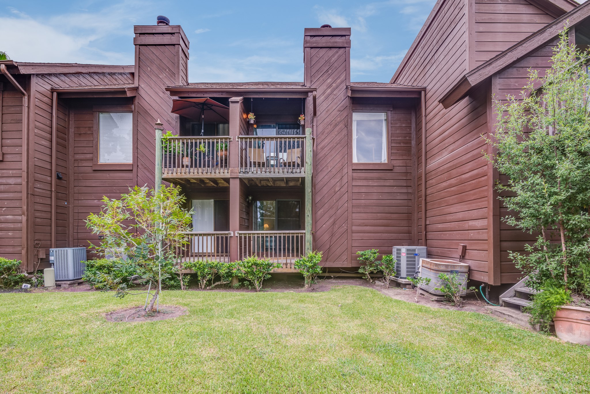 671 Davis Road League City, TX 77573 - Photo 29 of 34 a view of a brick house with plants and large tree
