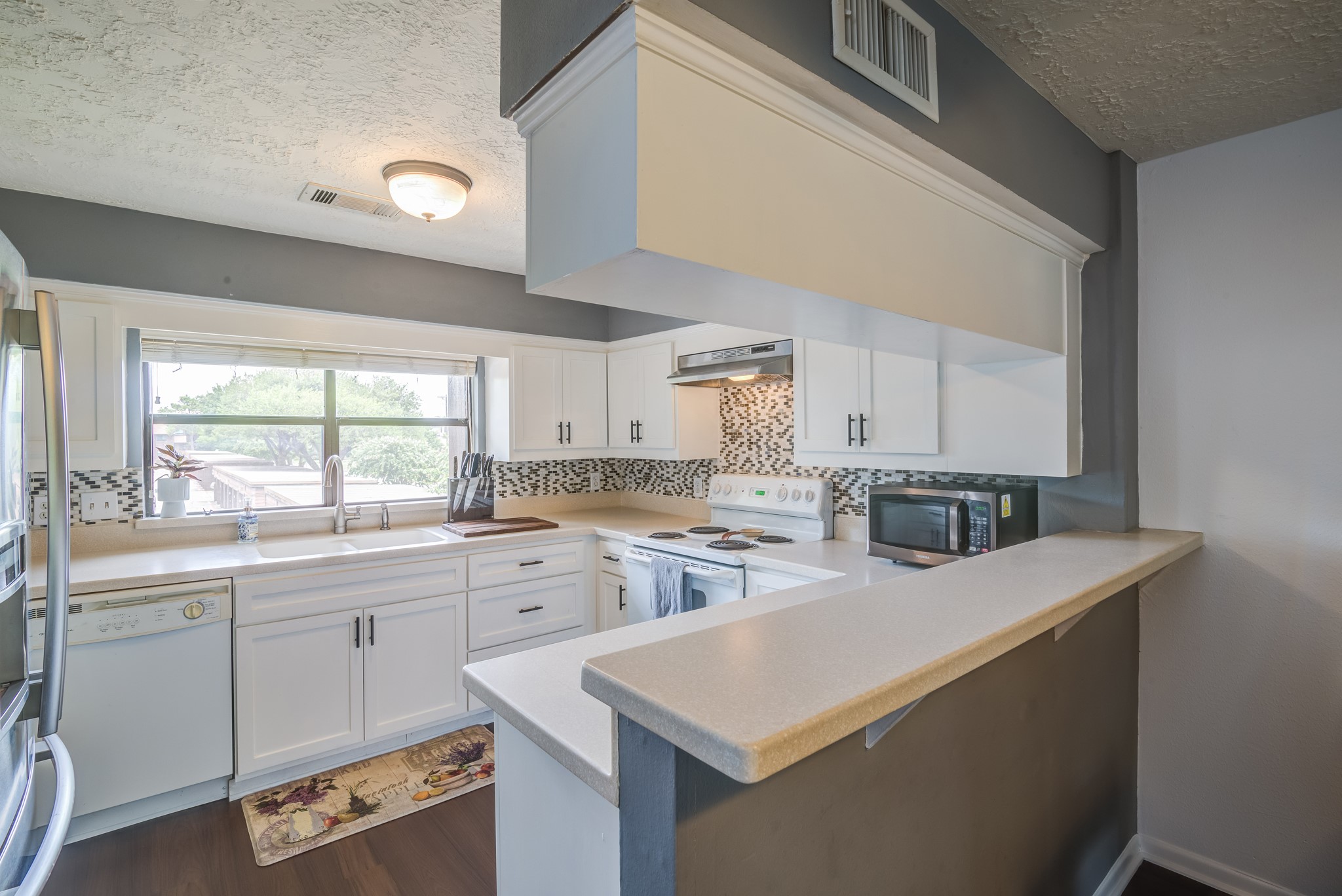 671 Davis Road League City, TX 77573 - Photo 4 of 34 a large white kitchen with sink stove and cabinets