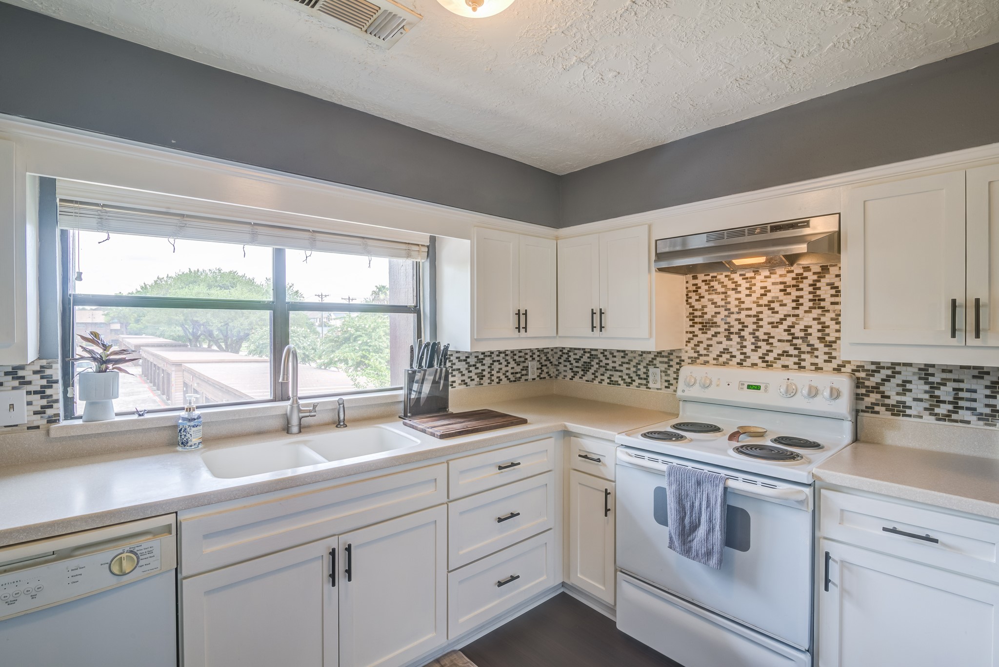 671 Davis Road League City, TX 77573 - Photo 6 of 34 a kitchen with granite countertop white cabinets white appliances and a sink