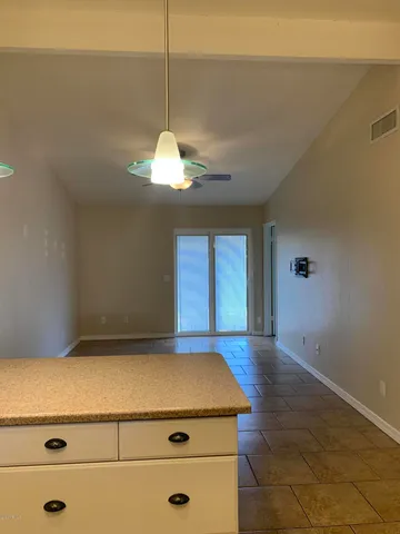 a kitchen with a cabinets and chandelier
