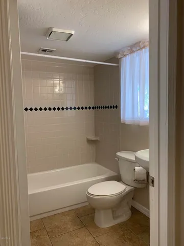 a bathroom with a toilet a sink and bathtub